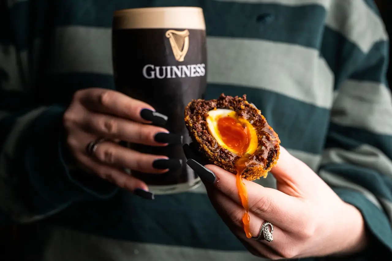 A pint of Guinness and a scotch egg at the bar